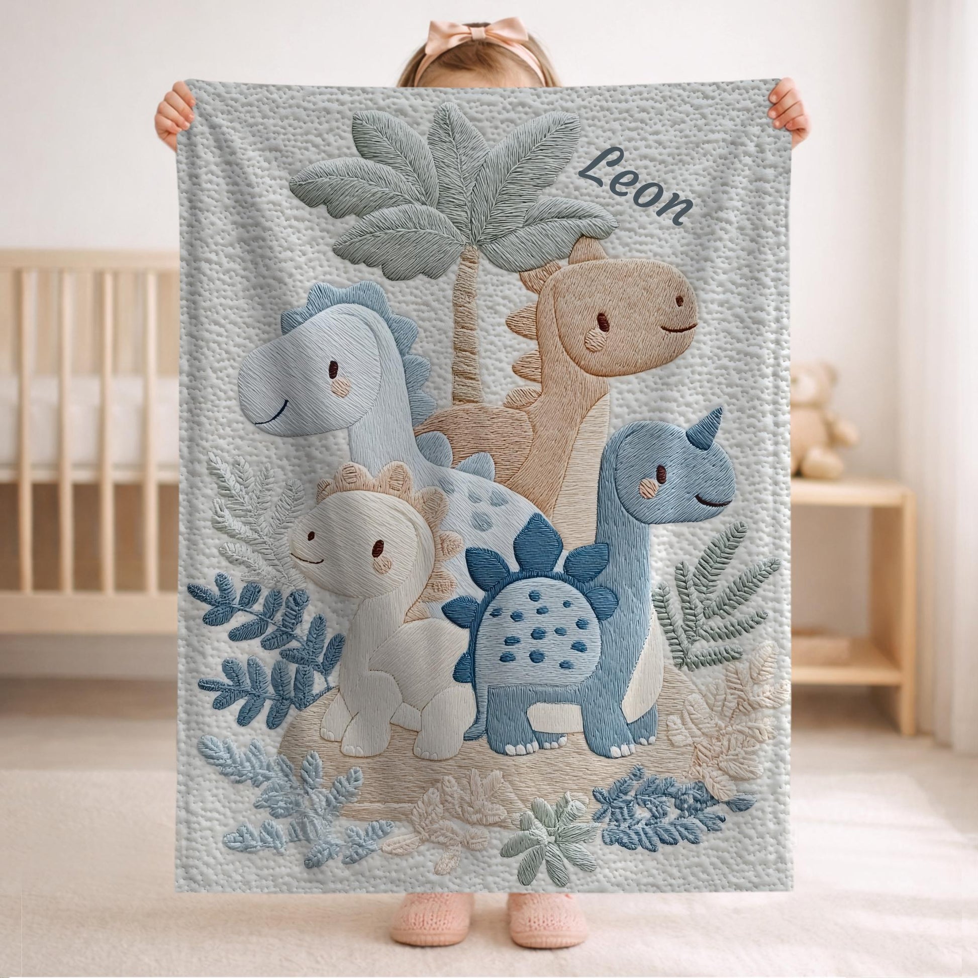 Personalized Dinosaur baby blanket with name - embroidered look details in soft neutral colors. A cozy newborn blanket and timeless boutique baby gift.