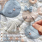 Soft embroidered-look baby blanket featuring a calm fish motif with delicate floral details. Gentle neutral and pastel tones — a timeless boutique-style gift for modern, serene nurseries.