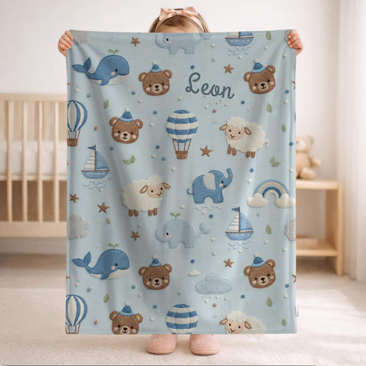 Personalized baby blanket with name in embroidery look. Sweet animals, hot air balloon & boat in calm earth tones – soft velveteen for nurseries.
