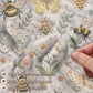 Garden baby blanket in embroidered quilt look. Butterfly and bee botanical design for neutral nursery decor and baby gift.