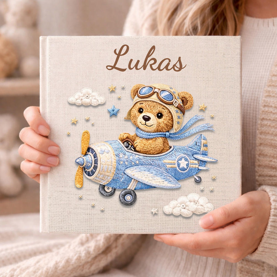 Personalized teddy bear airplane baby memory book with name and birth date. A soft aviation nursery album for first memories and milestones.
