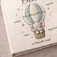 Personalized elephant baby memory album with hot air balloon design, custom name and optional birth date. A neutral nursery keepsake and timeless newborn photo book.