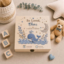 This stunning large wooden keepsake box (30cm / 12 inch) is made for a baby boy destined for great things. A full-color design printed directly onto the handcrafted wood features a chubby blue whale splashing through ocean waves, a sleepy crescent moon, delicate botanical sprigs, and gold and navy stars — all in a beautiful nautical palette of slate navy, cream, and warm gold.
Personalized with baby's name, exact date of birth, and time of birth.