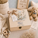 This magical large wooden keepsake box (30cm / 12 inch) is the perfect welcome for any new baby boy. A beautiful embroidered-style design printed directly onto the handcrafted wood features an adorable teddy bear resting on a cloud, surrounded by a crescent moon, twinkling stars, delicate botanical sprigs, and soft hearts — all in the most gentle, timeless palette of blue, cream, and gold.