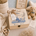 This stunning large wooden keepsake box (30cm / 12 inch) is made for a baby boy destined for great things. A full-color design printed directly onto the handcrafted wood features a chubby blue whale splashing through ocean waves, a sleepy crescent moon, delicate botanical sprigs, and gold and navy stars — all in a beautiful nautical palette of slate navy, cream, and warm gold.
Personalized with baby's name, exact date of birth, and time of birth.