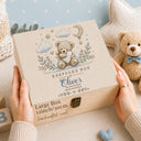 This magical large wooden keepsake box (30cm / 12 inch) is the perfect welcome for any new baby boy. A beautiful embroidered-style design printed directly onto the handcrafted wood features an adorable teddy bear resting on a cloud, surrounded by a crescent moon, twinkling stars, delicate botanical sprigs, and soft hearts — all in the most gentle, timeless palette of blue, cream, and gold.