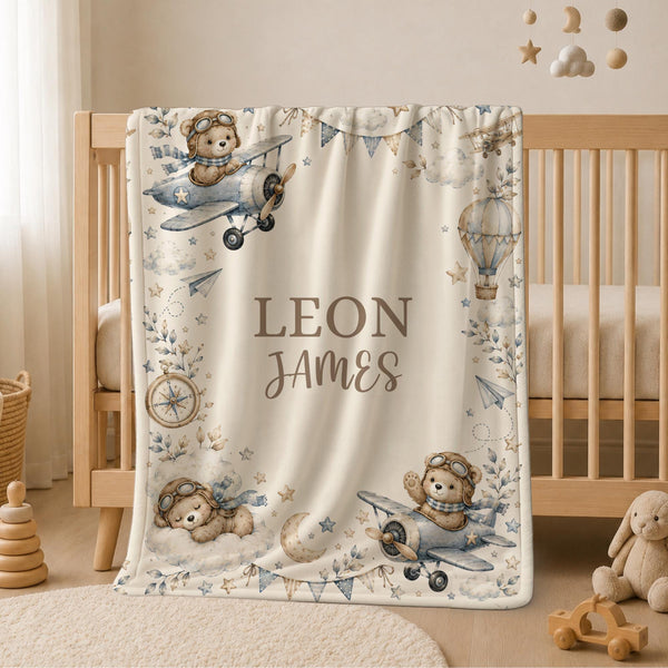 personalized aviator teddy blanket. Featuring charming watercolor bears, vintage airplanes, hot air balloons, and your child’s name, this cozy keepsake makes a beautiful nursery accent and thoughtful baby shower gift. Perfect for cuddles, stroller rides, nap time, and treasured memories.