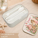 Personalized Fairy Bento Lunch Box featuring a dreamy watercolor fine art print with a sweet little fairy, magical flower cottage, butterflies, mushrooms and a whimsical enchanted garden filled with delicate flowers. Customized with your child’s name, this practical kids lunchbox is perfect for daycare, preschool, kindergarten, school, picnics and everyday adventures.