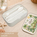 Personalized Crocodile Bento Lunch Box featuring a charming watercolor fine art print with a sweet crocodile, tropical palm trees, a toucan, frog, dragonflies, water lilies and a smiling sun. Customized with your child’s name, this practical kids lunchbox is perfect for daycare, preschool, kindergarten, school, picnics and everyday adventures.