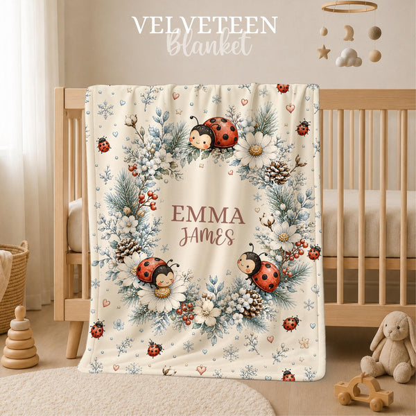 Celebrate your little one’s name with this personalized watercolor winter ladybug baby blanket, featuring sweet ladybugs surrounded by snowy white flowers, frosted blue foliage, winter berries, pinecones and delicate snowflakes.