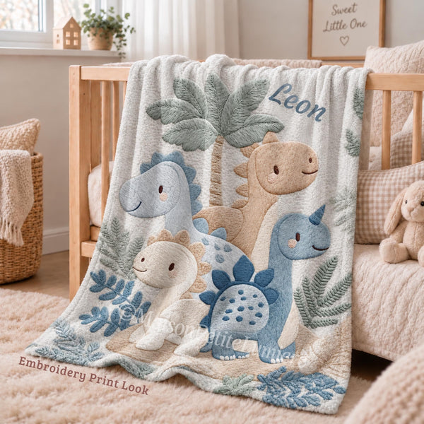 Personalized Dinosaur baby blanket with name - embroidered look details in soft neutral colors. A cozy newborn blanket and timeless boutique baby gift.