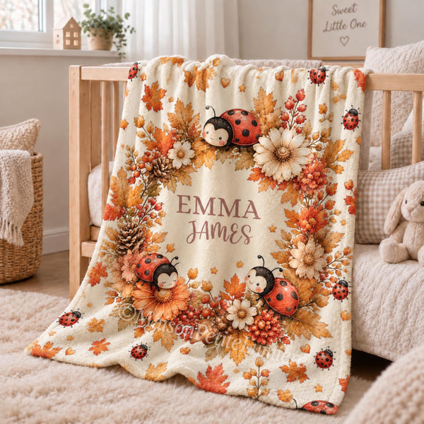 Celebrate your little one’s name with this personalized watercolor autumn ladybug baby blanket, featuring sweet ladybugs surrounded by warm fall leaves, autumn flowers, berries, pinecones and acorns.