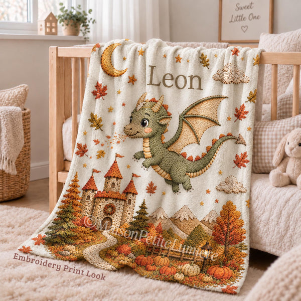 Personalized Dragon Baby Blanket with an embroidered-look print featuring a cute baby dragon, magical castle, autumn leaves, pumpkins, moon, stars and warm fall mountain scenery.