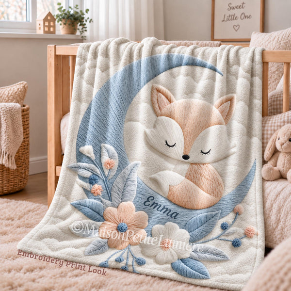 This personalized baby blanket features a dreamy sleeping fox nestled in a blue crescent moon, surrounded by soft florals and delicate leaves — printed in a beautiful embroidery-print style design made just for your little one.